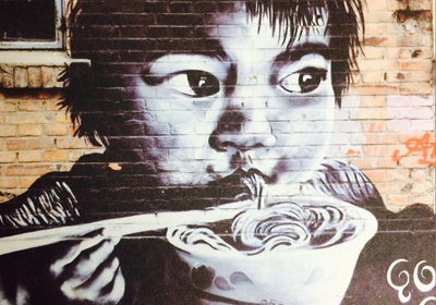 graffiti of a boy eating noodles